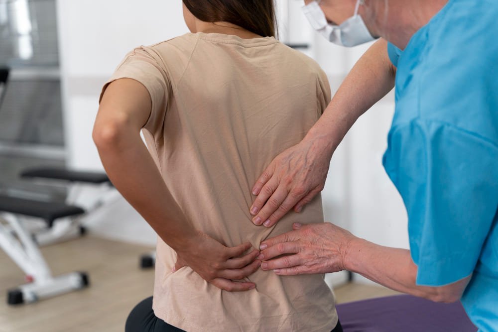 fisioterapeuta revisando espalda de paciente con dolor lumbar en consulta medica fisioterapeuta revisando espalda de paciente con dolor lumbar en consulta medica